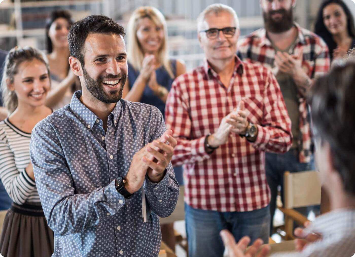 Professionals Standing In A Room Clapping For The Benefits Of Mailock Secure Email At Conference